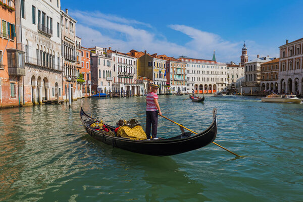 VENICE, ITALY - AUGUST 21, 2016: Tourists ride in gondola in Gra