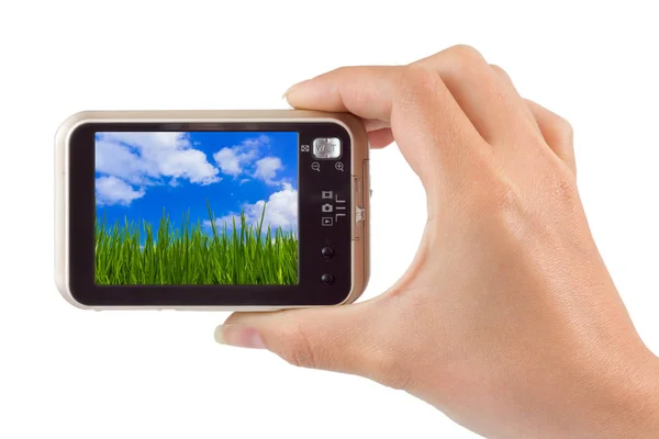 Hand with camera and Grass and cloudy sky (my photo) — Stock Photo, Image