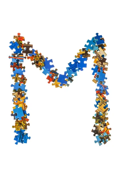 Carta M feita de peças de quebra-cabeça — Fotografia de Stock