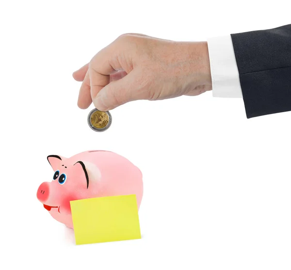 Piggy bank and hand with coin — Stock Photo, Image