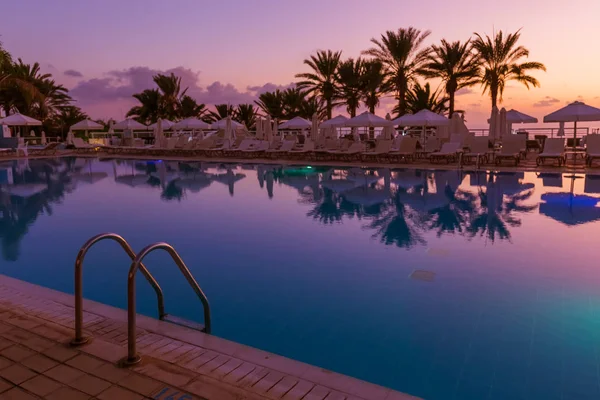 Swimming pool on Cyprus island at sunset — Stock Photo, Image