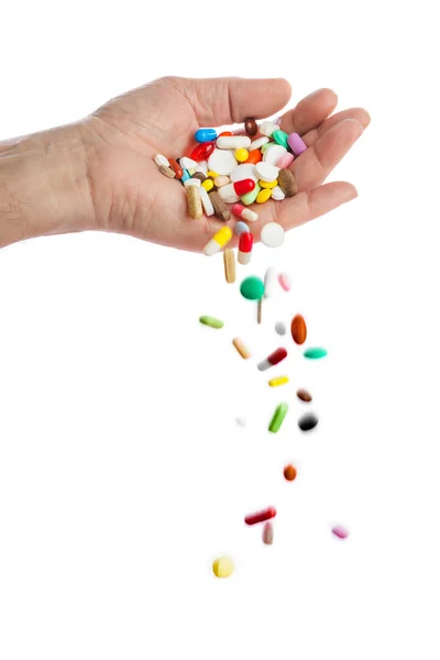 Hand och fallande piller — Stockfoto