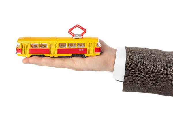 Ręka z tramwajem zabawki — Zdjęcie stockowe