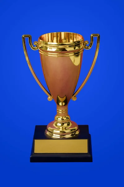 Golden trophy cup on blue — 스톡 사진