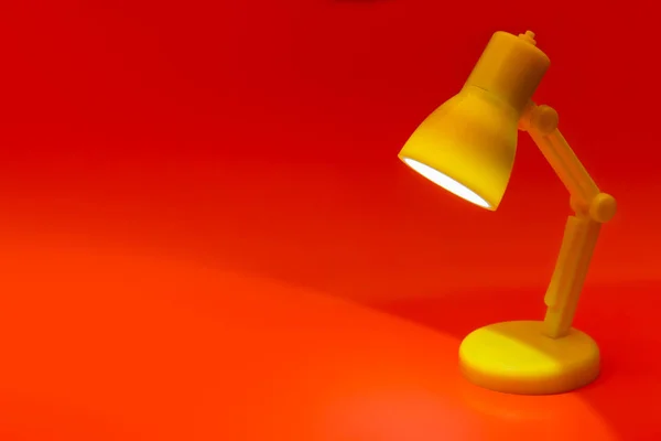 Desk lamp on red — Stock Photo, Image