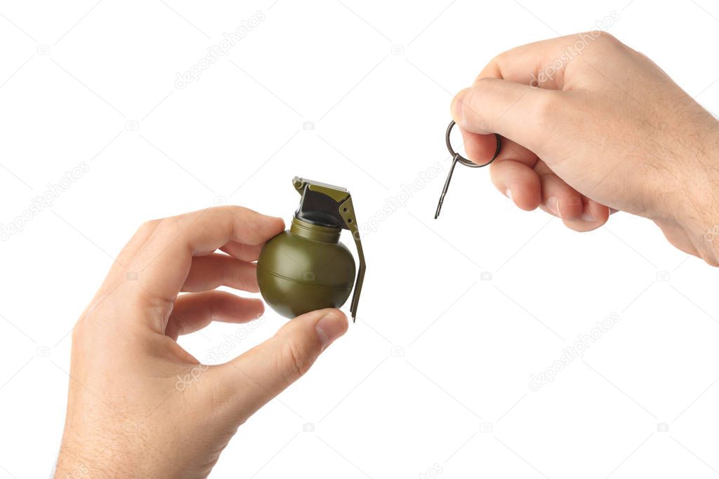 Hand pulls a check from a grenade isolated on white background