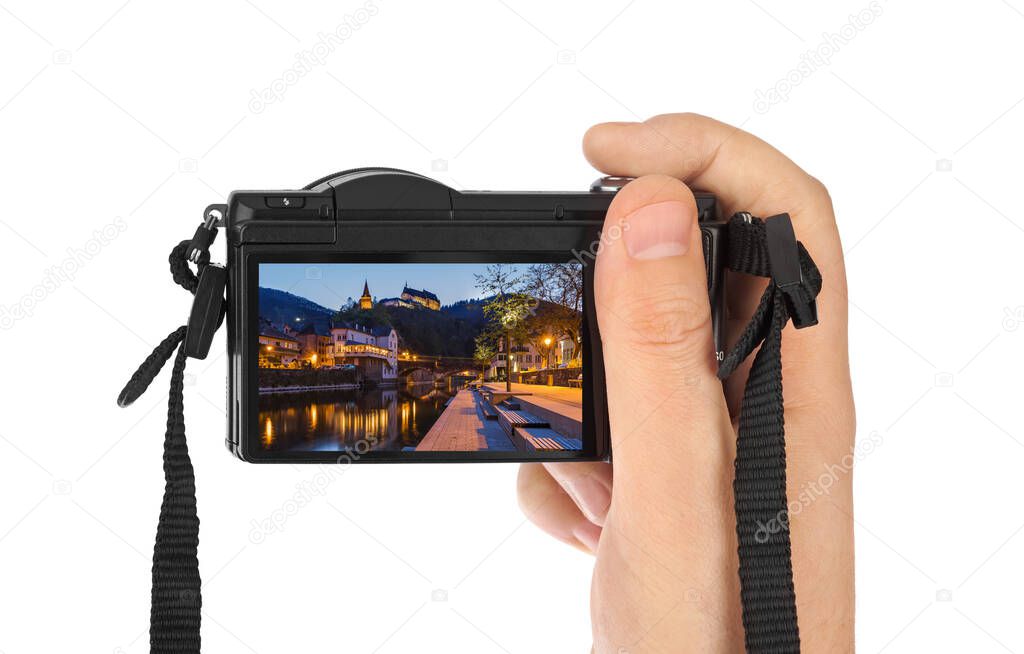 Hand with camera and Vianden castle in Luxembourg (my photo) isolated on white background