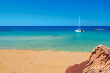 Cala Del Pilar beach with saturated golden send at Menorca clipart
