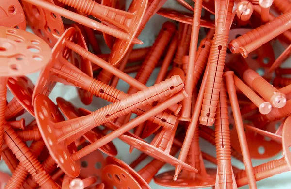 Background of many red plastic dowels for thermal insulation. — Stock Photo, Image