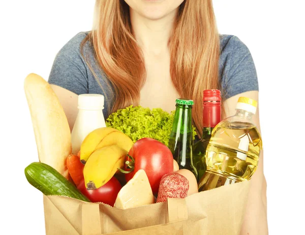 Mujer mantiene bolsa con diferentes productos —  Fotos de Stock