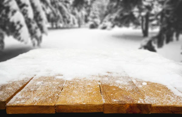 Wooden desk covered by snow