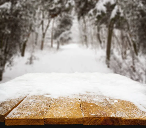 Wooden desk covered with snow