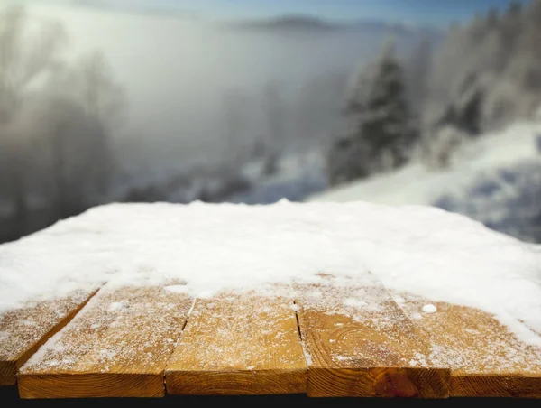 Wooden desk covered with snow