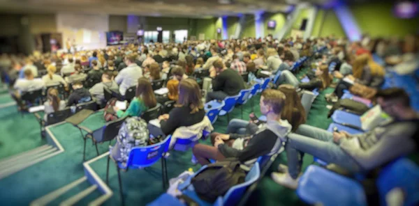 Viele junge Leute im großen Saal lauschen einem Redner — Stockfoto