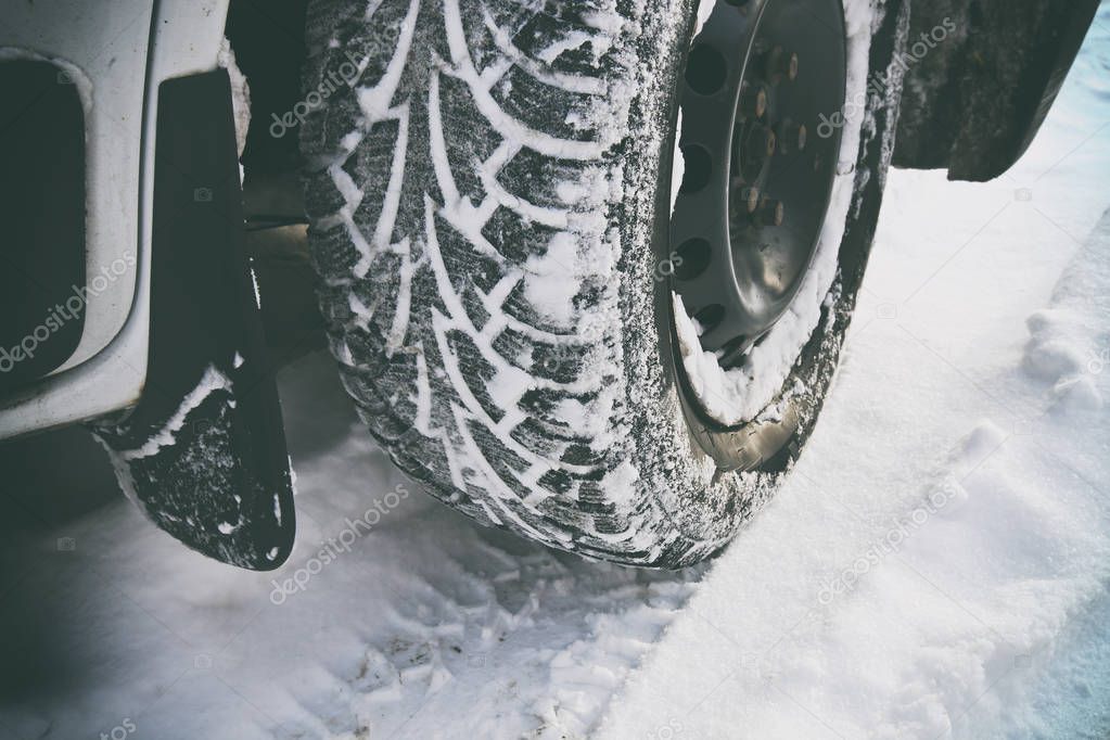 Car's tire covered by snow — Stock Photo © Olegkalina 176122524