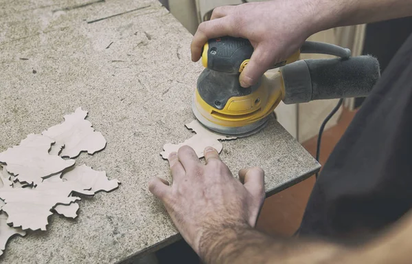 The man is processing with wood by polishing machine — Stock Photo, Image