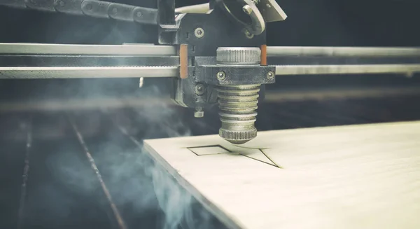 Laser cutting machine is cutting the wooden plank — Stock Photo, Image