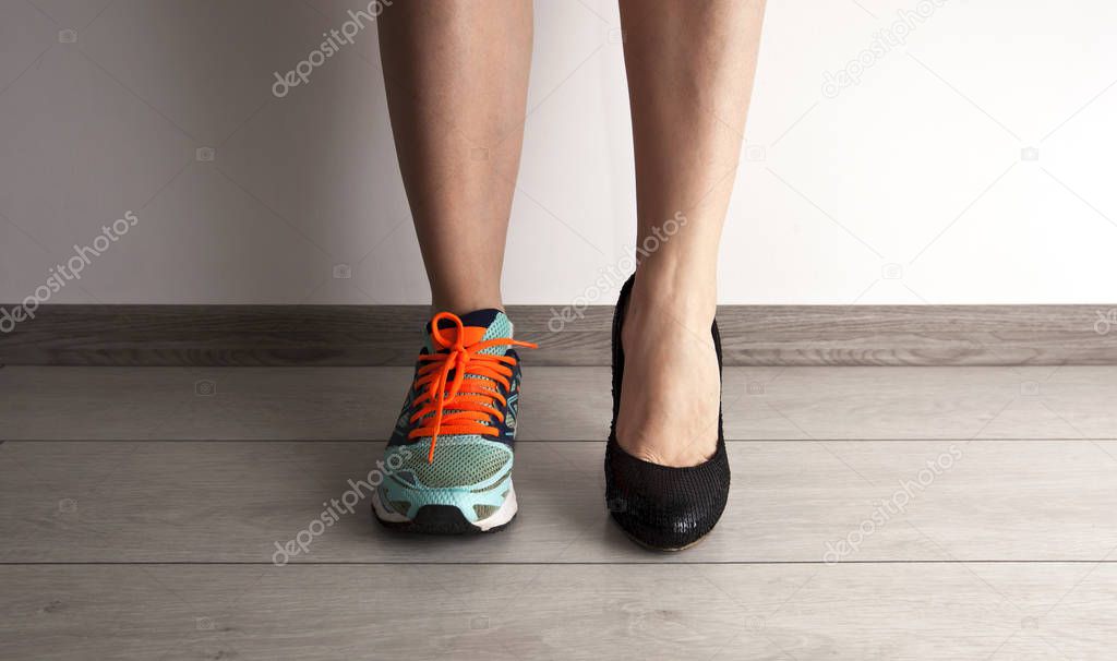Two different types of shoes on the woman's foots