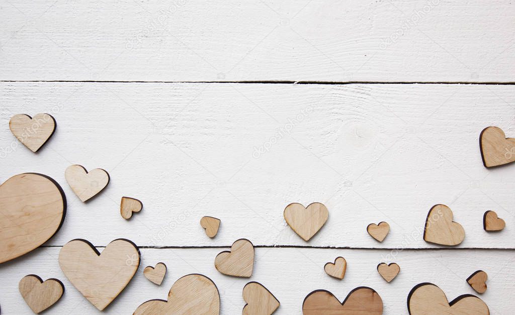 A beautiful background with  lot of wooden hearts on the white t
