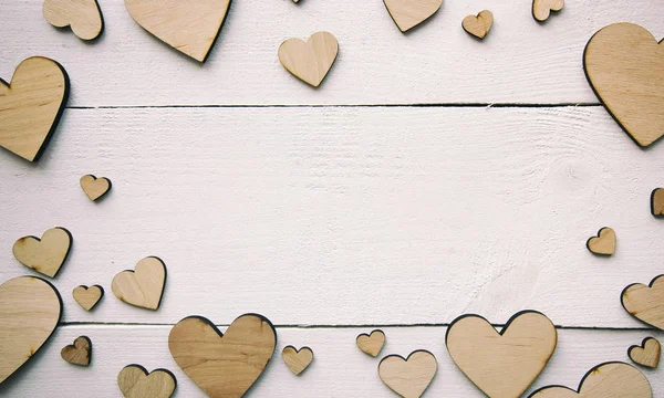 A beautiful background with  lot of wooden hearts on the white t — 스톡 사진