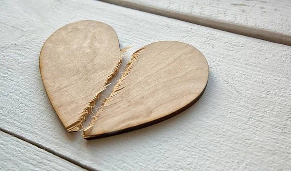 The broken wooden heart on the wooden table. Concept of the divo — 스톡 사진