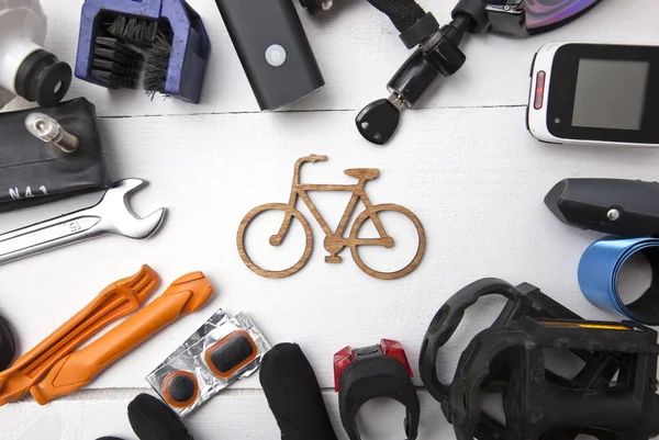 Veel verschillende fietsaccessoires liggend op houten tafel aro — Stockfoto