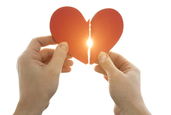 The woman is holding two parts of broken heart in her hads in fr — Stock Photo, Image