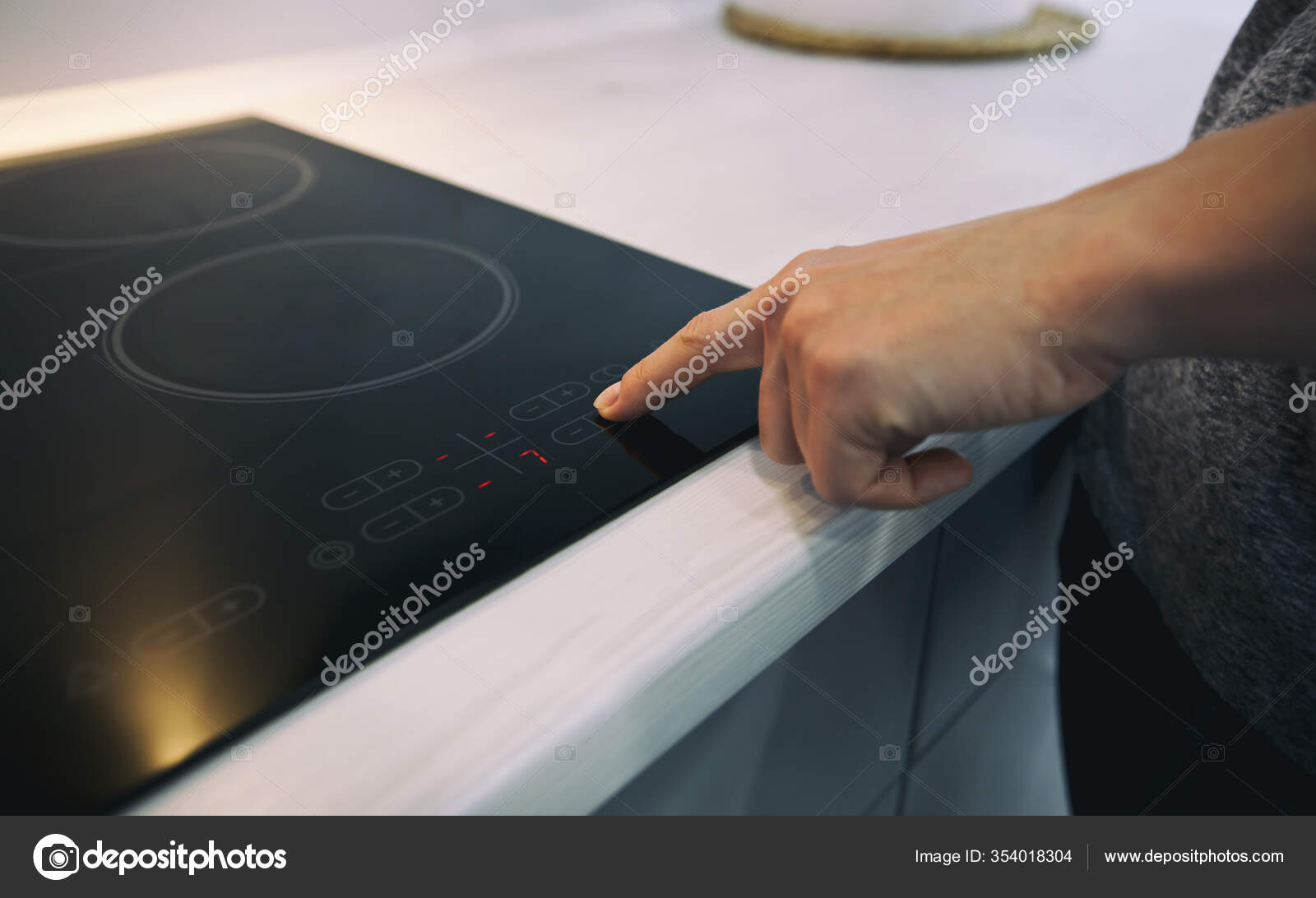 Woman Touching Sensor Button Electric Stove Stock Photo by ©Olegkalina