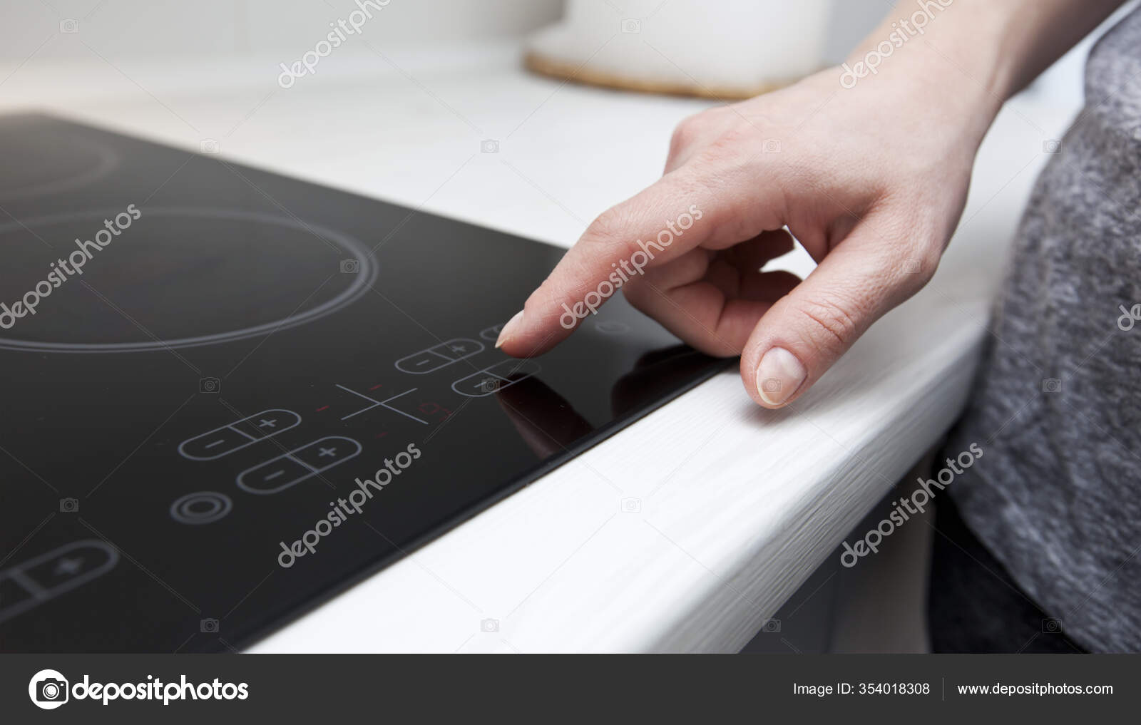 Woman Touching Sensor Button Electric Stove Stock Photo by ©Olegkalina