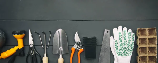 A lot of different garden equipment on the wooden table