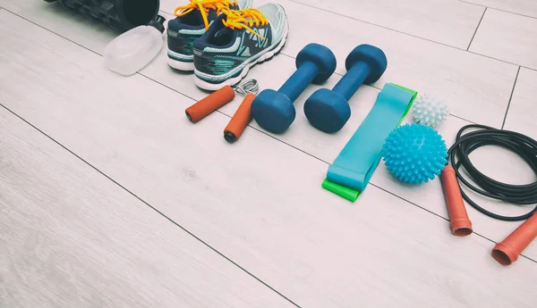 The fitness tools and  a equipment on the wooden floor. Concept of home physical training and staying at home