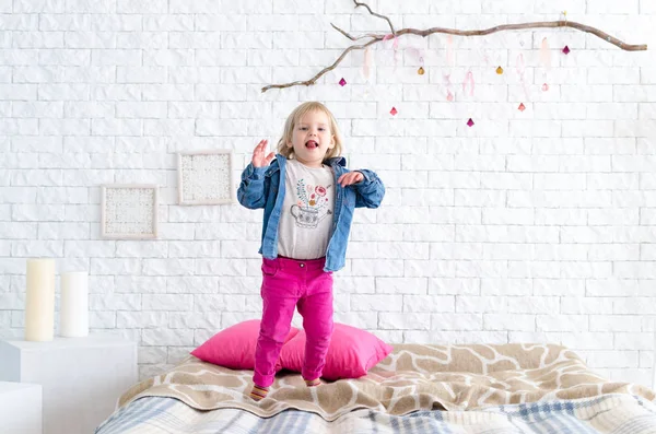 Feliz niña salta en la cama — Foto de Stock