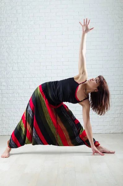 Woman practice in yoga. Teacher of yoga. Indoor training.