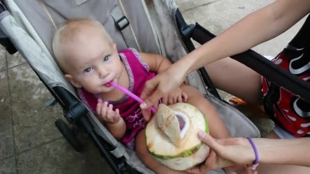 Ребенок пьет кокос из соломы . — стоковое видео