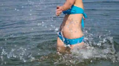 Güzel kız denizde su sıçramalarına.