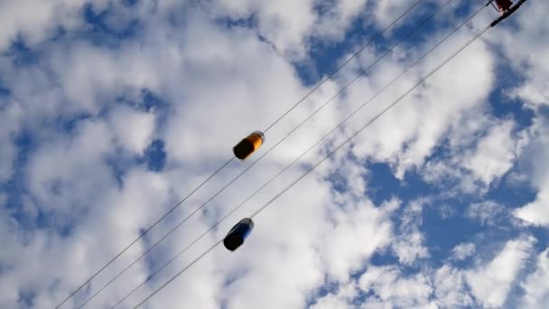 Temps d'attente d'un petit téléphérique. Cabines multicolores flottant contre le ciel bleu . — Video