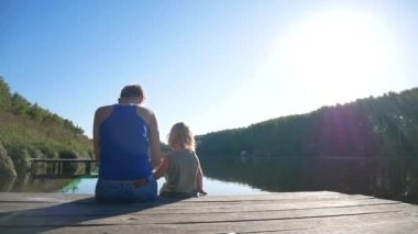 Anne ve kızı iskelede ve doğanın tadını çıkarın. Aile tatilleri.