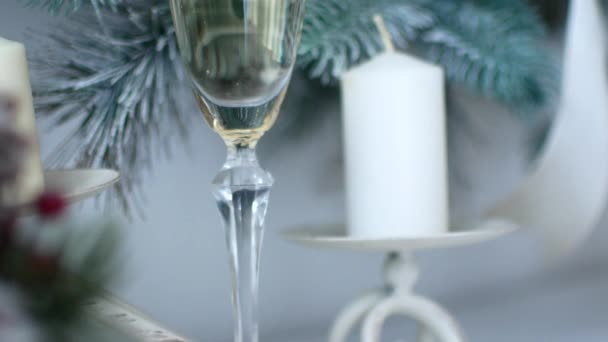 Christmas spirit. A glass of champagne in the New Years decor of the house — Stock Video