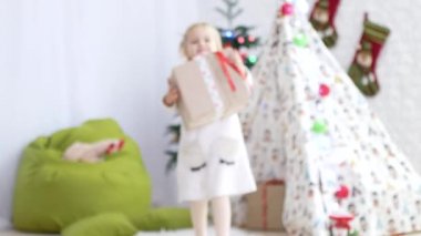 Çocuk bir hediye kameraya taşıyor. Noel ruh hali, zaman mucizeler ve hediyeler