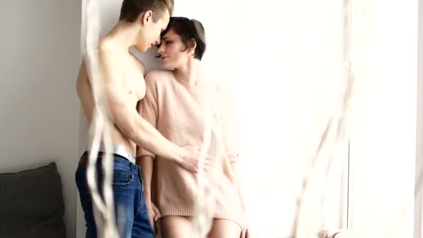 Young and sexy couple in love. Beautiful half-naked guy and girl embrace. Sensual and passionate couple — Stock Video
