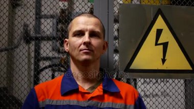 Yüksek tansiyon belirtisi yakınındaki bir kask üzerinde işçinin koyar. Kurumsal güvenlik