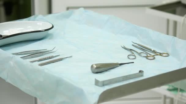Consultorio dental. Preparándose para la cirugía, las herramientas se colocan en una mesa estéril — Vídeos de Stock
