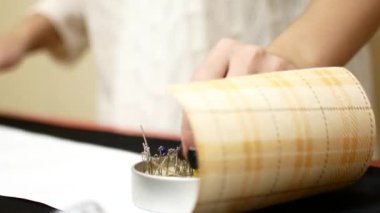 Çengelli iğne Yataklı. Kadın terzi çengelli iğne iğne yatağın çeker. Araçlar ve dikiş aksesuarları