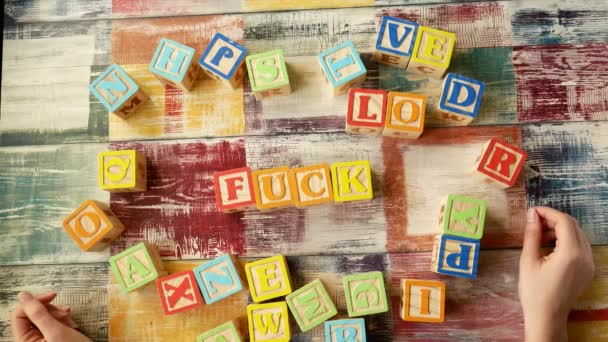 Falling toy bricks make up different words — Stock Video