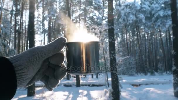 Рука людини в рукавичках тримає чашки з гарячим напоєм . — стокове відео
