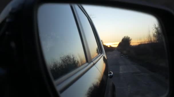 Back road reflected in car mirror, car driving fast — Stock Video