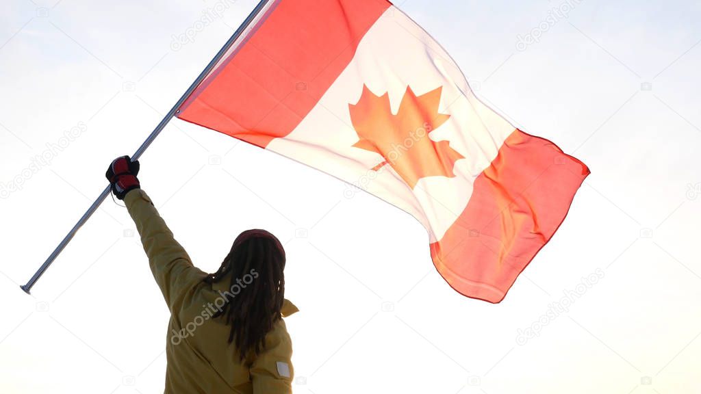 Man on the top with Canadian flag. Winner and motivation concept