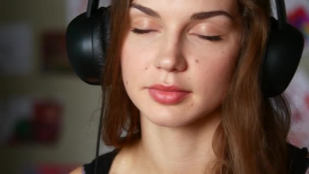 Mooie vrouw met koptelefoon luisteren naar de muziek — Stockvideo