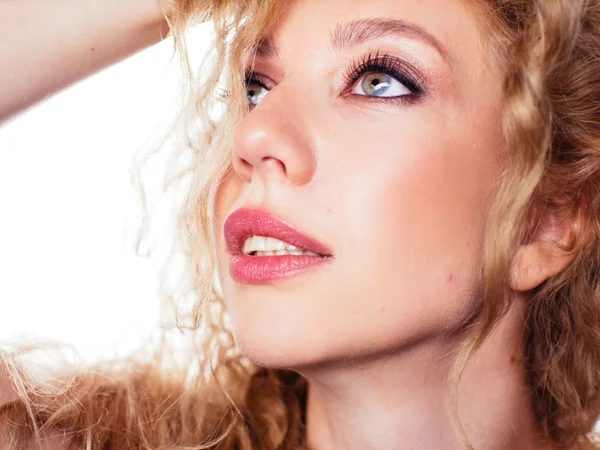 Portrait of a young beautiful girl with curly hair. Emotional cheerful woman on a white background. — Stock Photo, Image