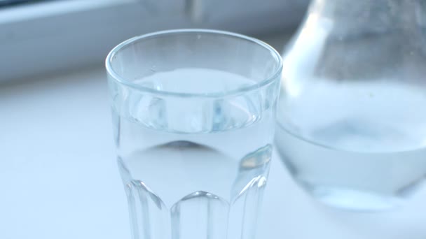 Un enfant jette un comprimé d'aspirine soluble dans un verre d'eau 